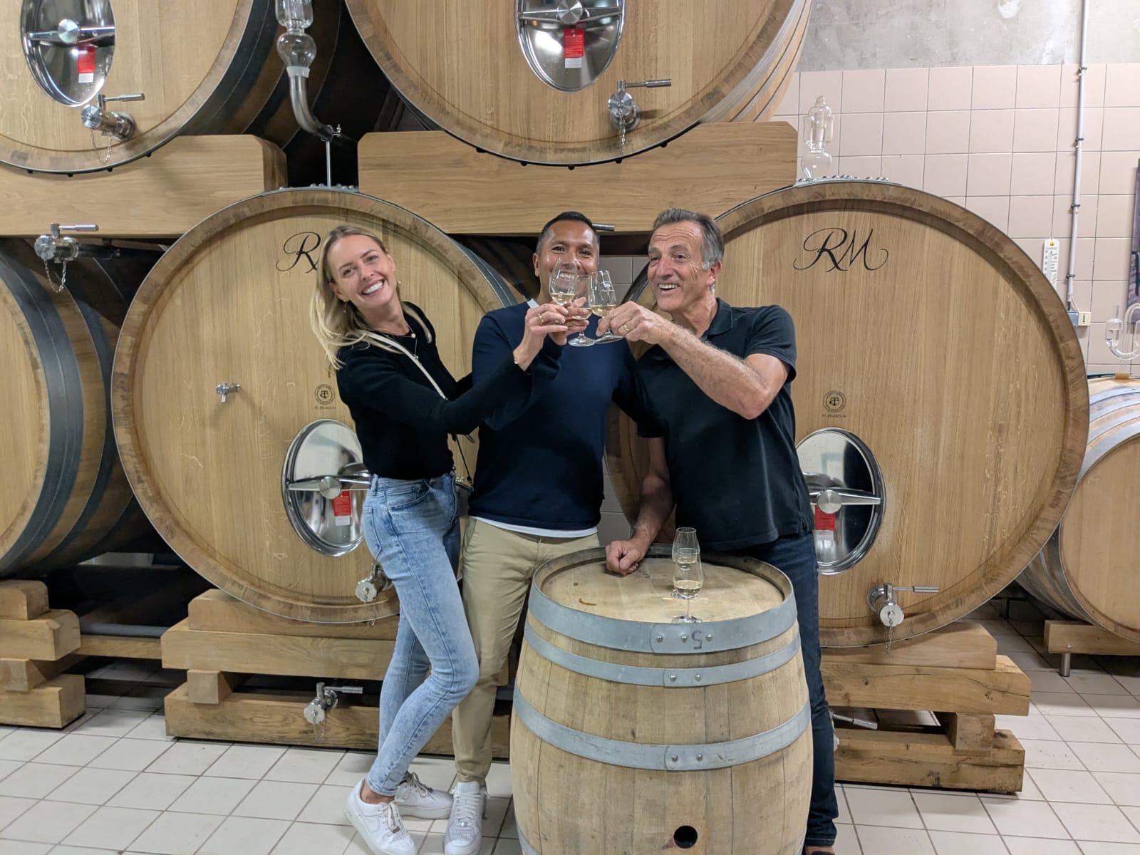 Tasting among wine barrels